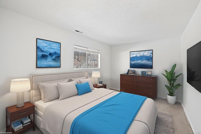 carpeted bedroom featuring a textured ceiling