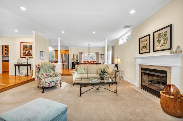 living room with crown molding, light carpet, and ornate columns