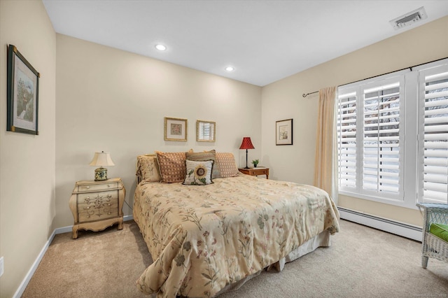 bedroom featuring light colored carpet and a baseboard heating unit