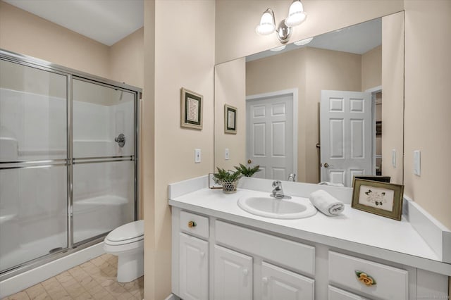 bathroom featuring vanity, toilet, and a shower with door