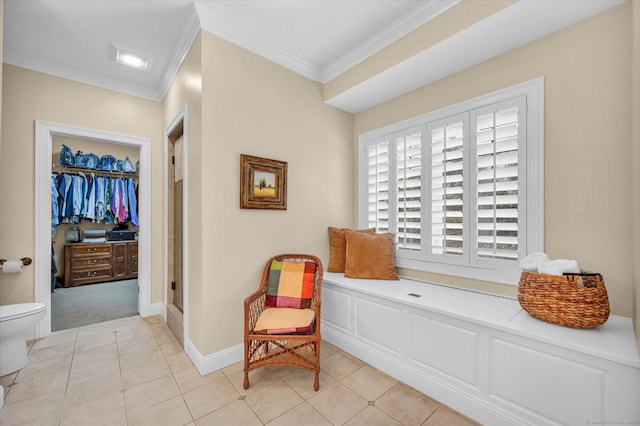 living area featuring ornamental molding and light tile patterned floors