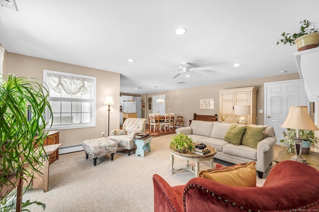 carpeted living room featuring ceiling fan and a baseboard radiator