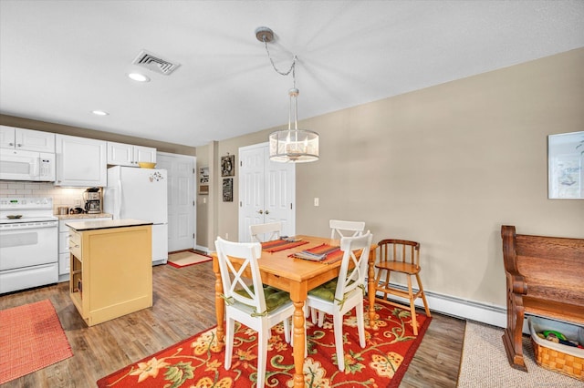 dining room with hardwood / wood-style flooring