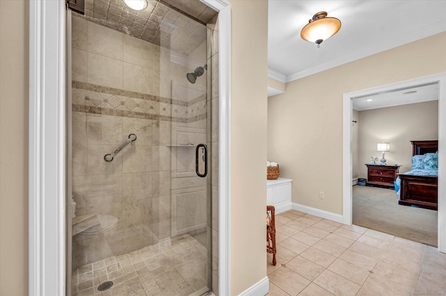 bathroom with tile patterned flooring, crown molding, and a shower with door