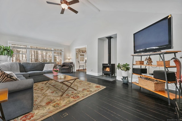 living room featuring a wood stove, beam ceiling, ceiling fan, high vaulted ceiling, and dark hardwood / wood-style floors