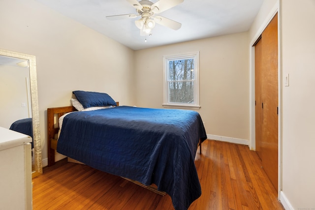 bedroom with a closet, ceiling fan, and light hardwood / wood-style flooring