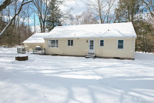 snow covered rear of property with central AC unit