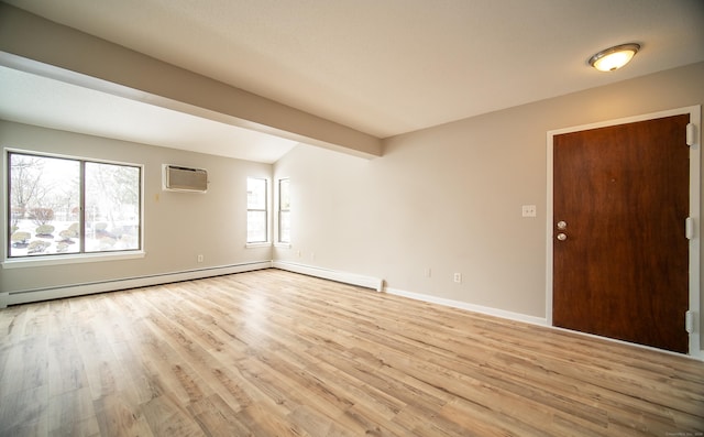 unfurnished room with beam ceiling, a baseboard heating unit, a wall unit AC, and light hardwood / wood-style floors