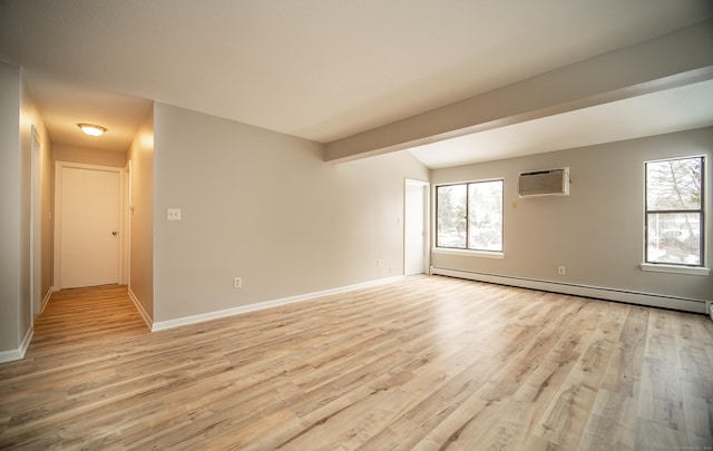 unfurnished room featuring a wall unit AC, light hardwood / wood-style floors, and baseboard heating