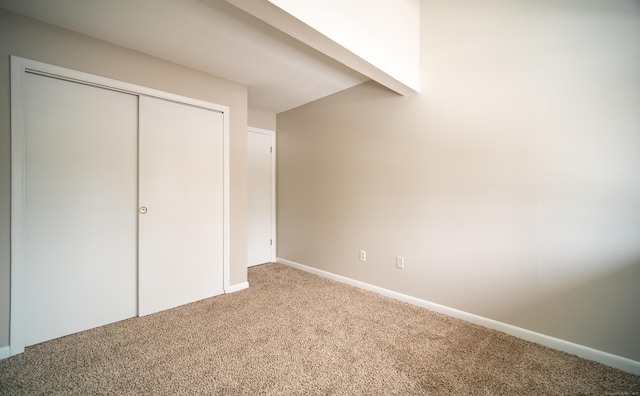 unfurnished bedroom with carpet floors and a closet