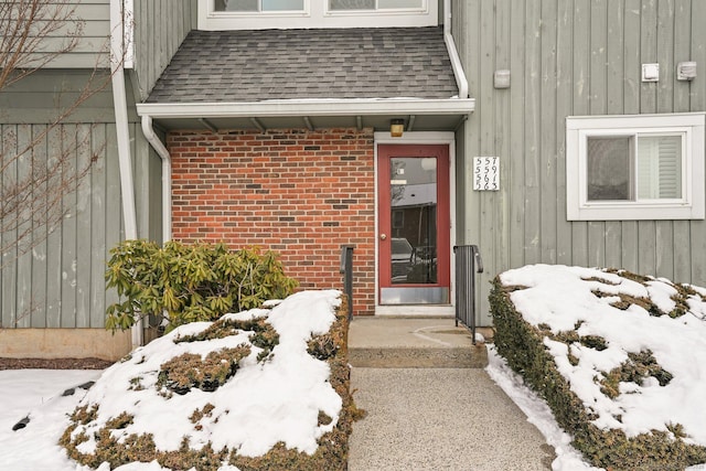 view of snow covered property entrance