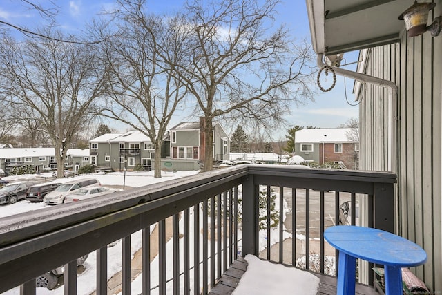 view of snow covered back of property