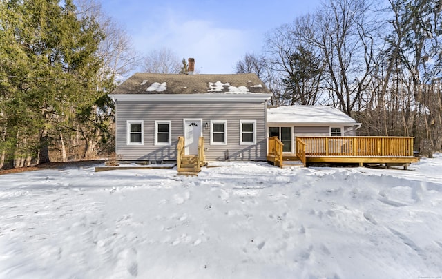 snow covered property with a deck