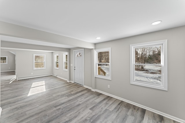 entrance foyer featuring light hardwood / wood-style flooring and a baseboard heating unit