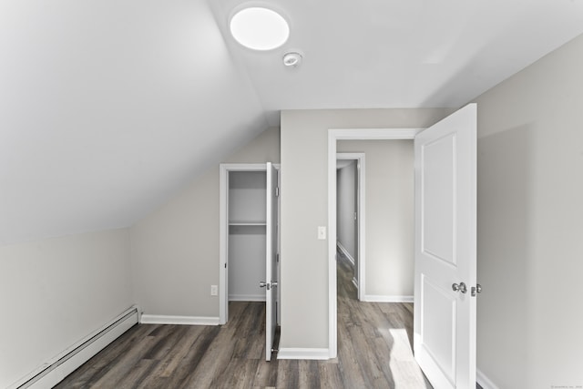 bonus room with a baseboard radiator, lofted ceiling, and dark hardwood / wood-style floors