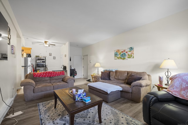 living room featuring ceiling fan and hardwood / wood-style floors