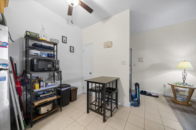 home office with light tile patterned floors and ceiling fan