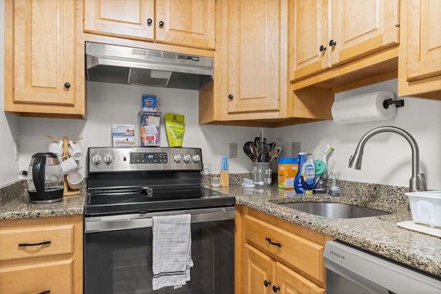 kitchen featuring sink, light brown cabinets, light stone countertops, and appliances with stainless steel finishes