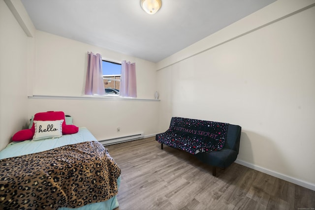 bedroom with hardwood / wood-style flooring and a baseboard radiator