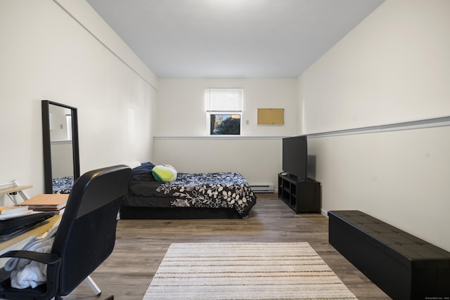 bedroom featuring wood-type flooring and a baseboard radiator