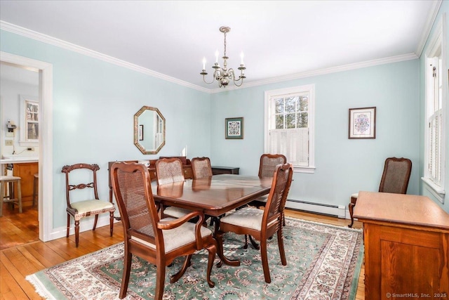 dining room with a baseboard radiator, ornamental molding, a chandelier, and light hardwood / wood-style flooring