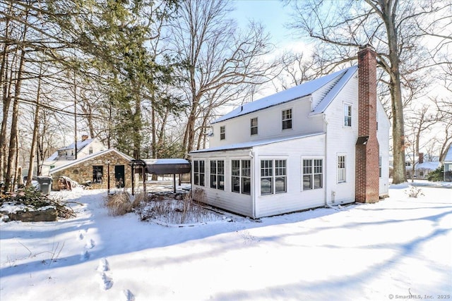 view of snow covered rear of property