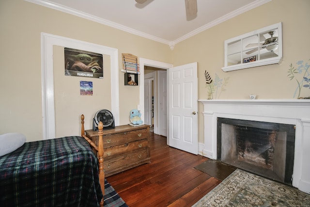 bedroom with dark wood-type flooring, ceiling fan, and ornamental molding