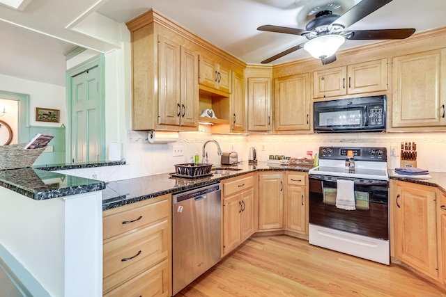 kitchen with range with electric stovetop, dishwasher, sink, dark stone countertops, and light hardwood / wood-style flooring