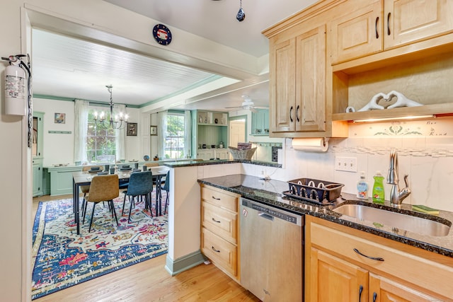 kitchen with sink, stainless steel dishwasher, light brown cabinetry, and dark stone counters