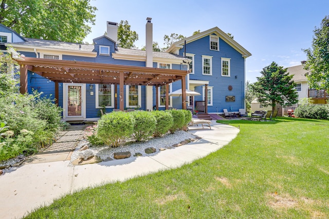 back of house with a lawn and a patio