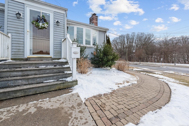 view of snow covered property entrance