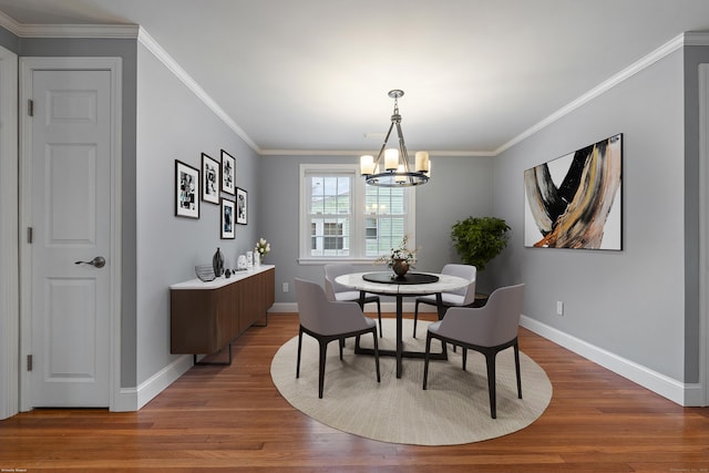 dining space featuring ornamental molding, dark hardwood / wood-style floors, and a chandelier