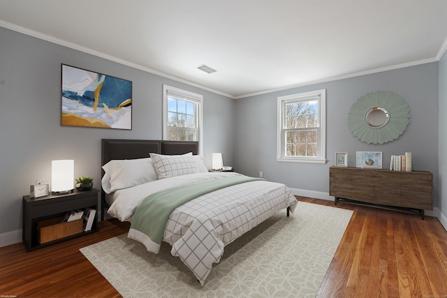 bedroom with ornamental molding and hardwood / wood-style floors