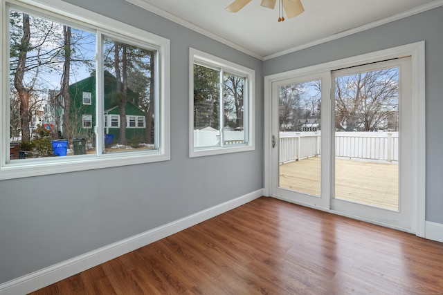 unfurnished sunroom featuring ceiling fan