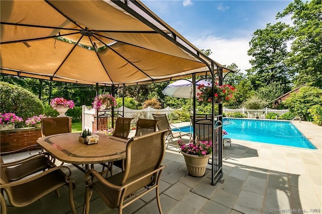 view of swimming pool with a gazebo and a patio area