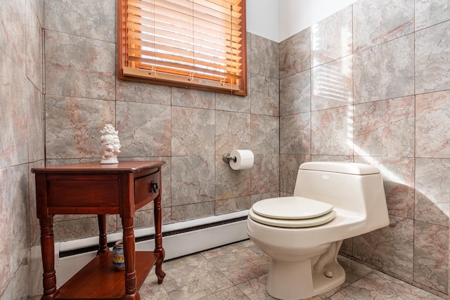 bathroom featuring toilet and tile walls