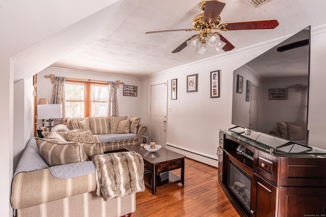 living room with baseboard heating, ornamental molding, a textured ceiling, and light wood-type flooring