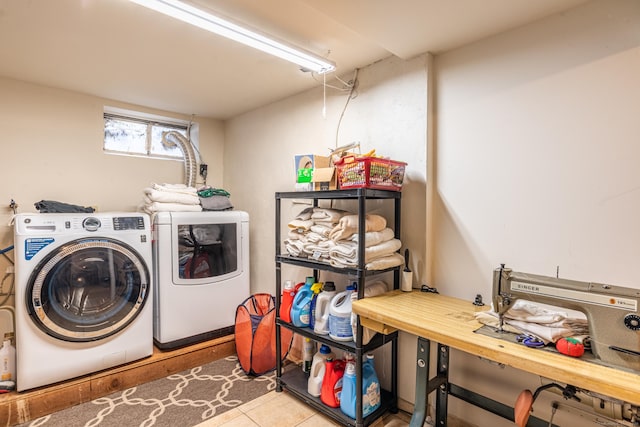 clothes washing area featuring independent washer and dryer and light tile patterned floors