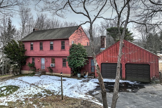 view of front facade featuring a garage and cooling unit