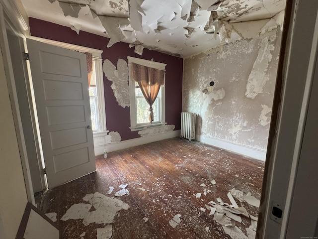 interior space featuring radiator heating unit and baseboards