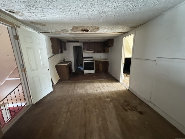 hall with a textured ceiling and dark wood-type flooring