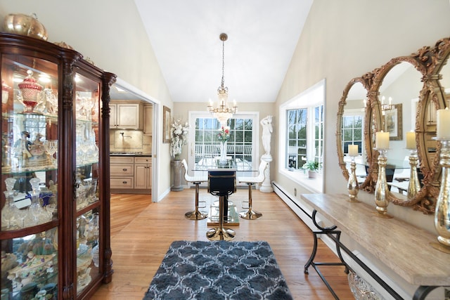 interior space with an inviting chandelier, light hardwood / wood-style flooring, and a healthy amount of sunlight