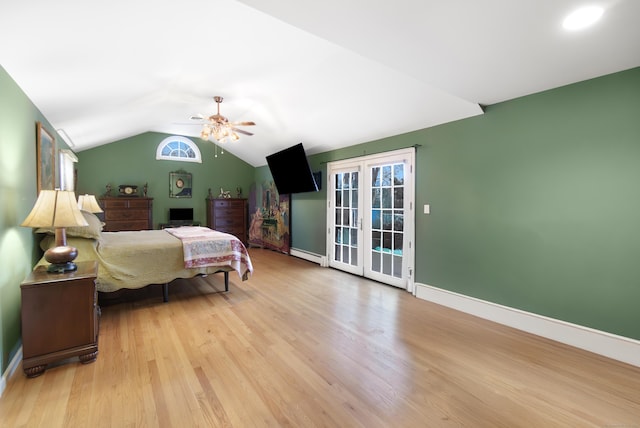 bedroom with access to exterior, vaulted ceiling, light hardwood / wood-style flooring, and a baseboard heating unit