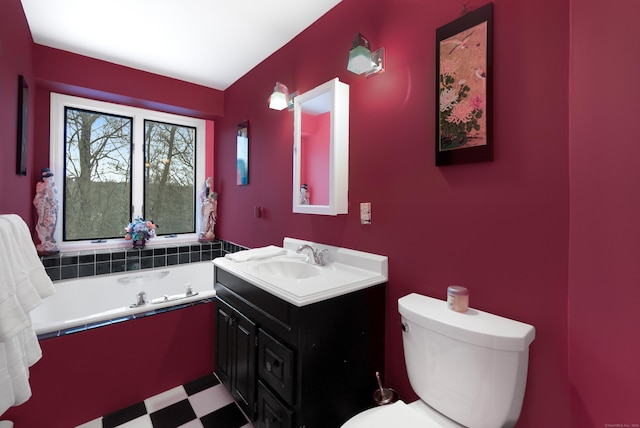 bathroom featuring vanity, a tub, and toilet