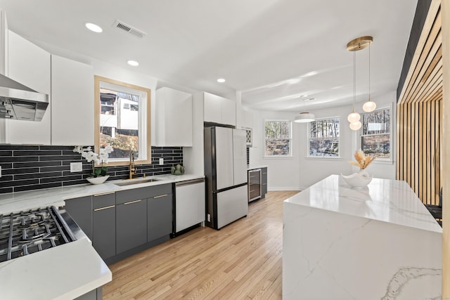 765 Durham Rd, Guilford, CT 06437 - kitchen with freestanding refrigerator, white cabinets, wine cooler, dishwashing machine, and a sink