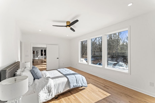 bedroom with ceiling fan and light wood-type flooring