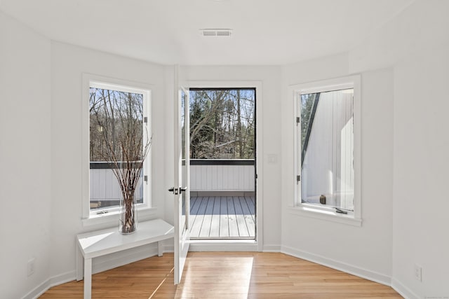 doorway to outside with light wood-type flooring