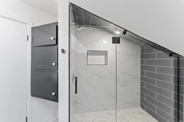 bathroom featuring a shower with door