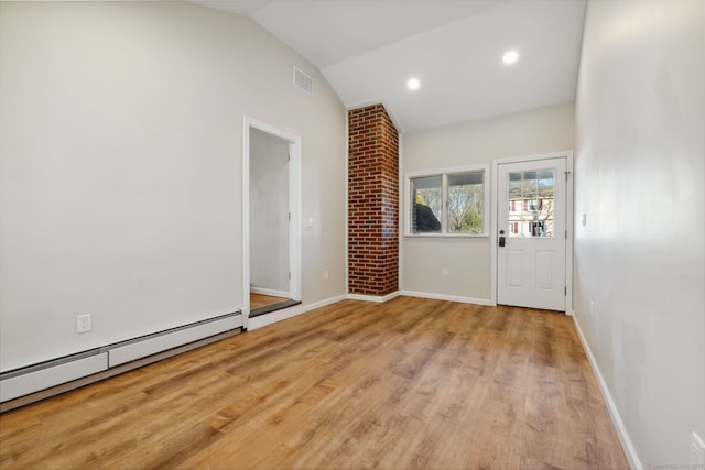 entrance foyer with lofted ceiling, a baseboard heating unit, and light wood-type flooring