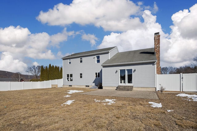 rear view of house with a patio and a lawn